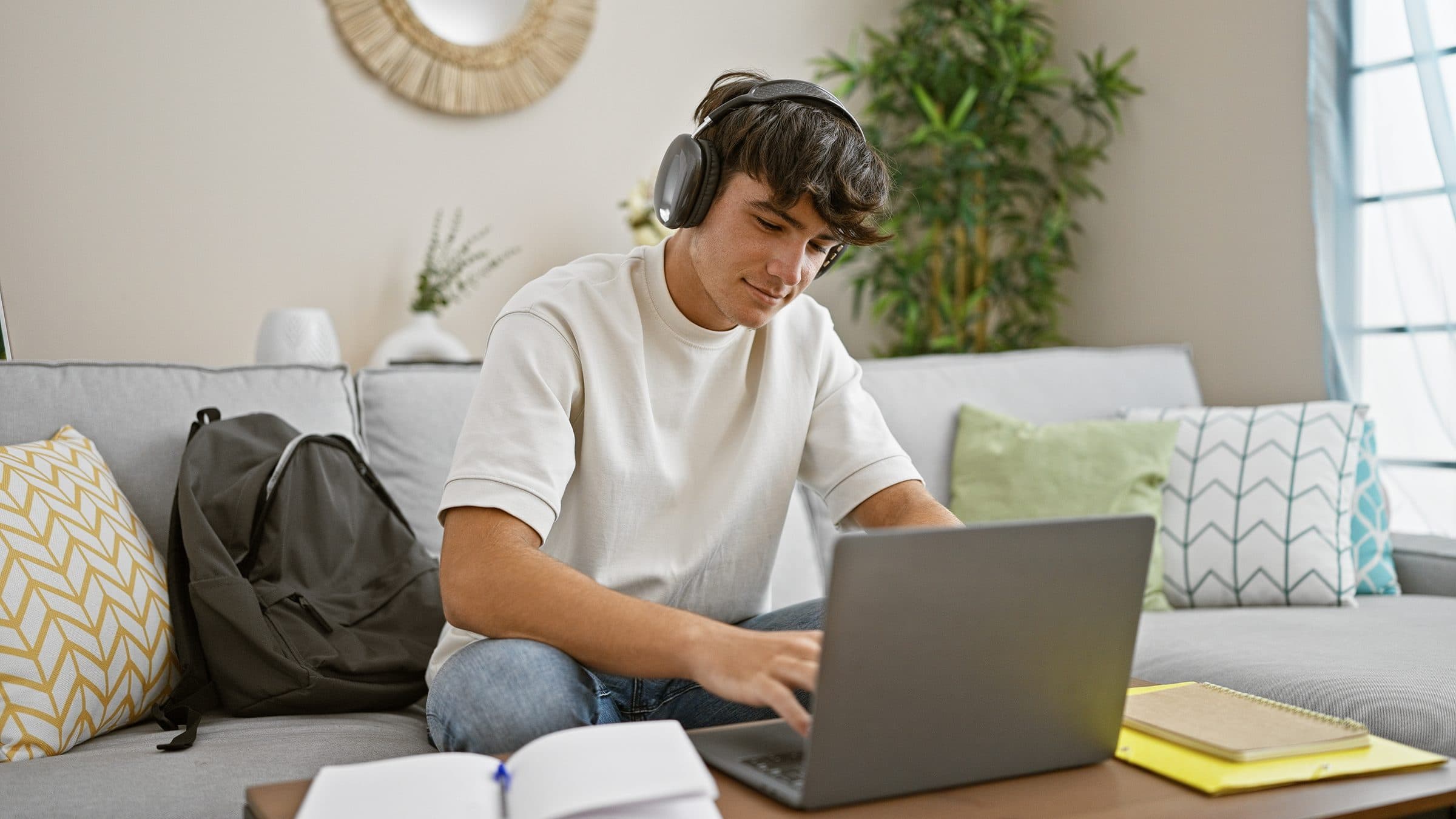 A UTVA student studying at home with headphones and a laptop